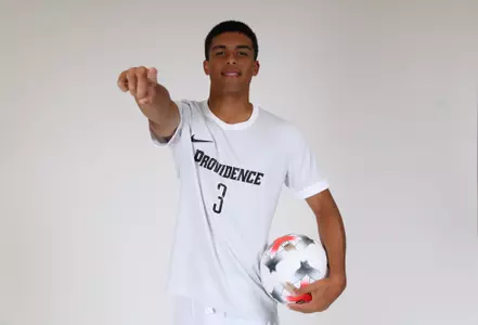 Ian Morel ball on hip while pointing at the camera 