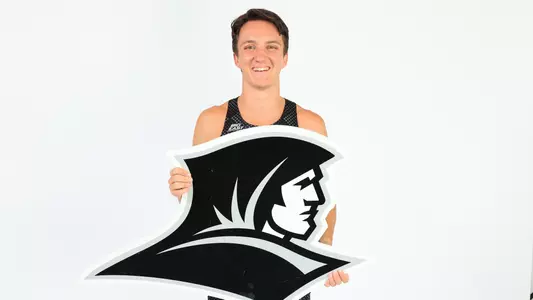 Adam Wedlake holding the Friars Logo during a photo shoot