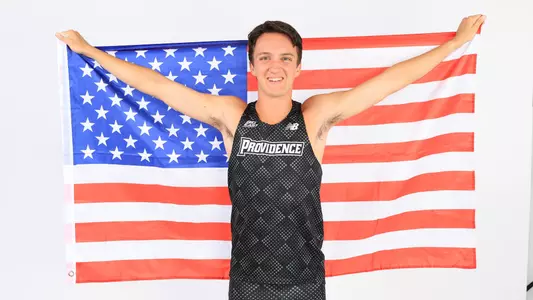 Adam Wedlake holding the American flag during a photo shoot 