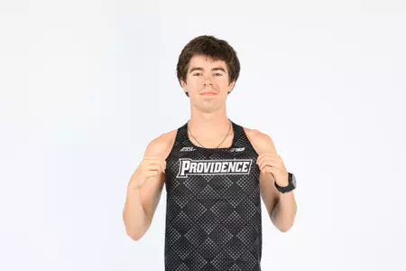 David Hayes holding his jersey out to pose during a photo shoot