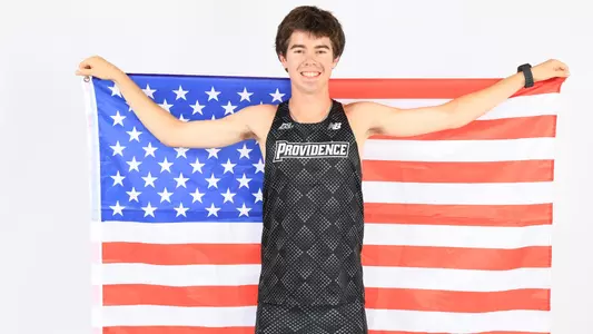 David Hayes posing with the American flag during a photo shoot