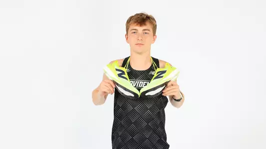 Daniel Prescott holding running shoes around his shoulders during a photo shoot