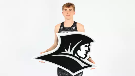 Daniel Prescott holding up the Friars logo during a photo shoot