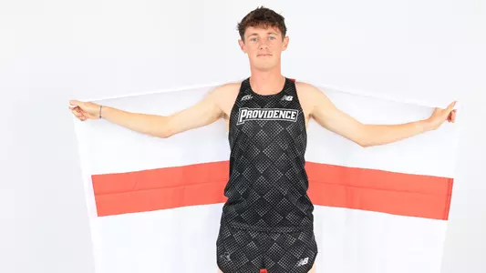 Jack Small holding up the flag of England during a photo shoot 