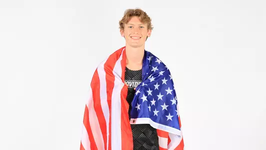 Jeb Hillary posing with the American flag around his shoulders during a photo shoot 