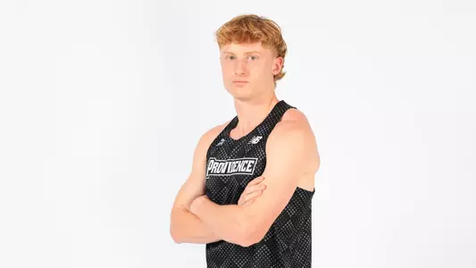 Oliver Neate posing with his arms crossed during a photo shoot 