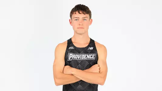 Jack Dowd posing with his arms crossed during a photo shoot