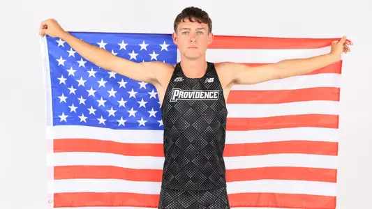 Jack Dowd holding up the American flag during a photo shoot 
