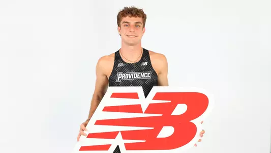 Ryan LoCicero holding the New Balance logo during a photo shoot