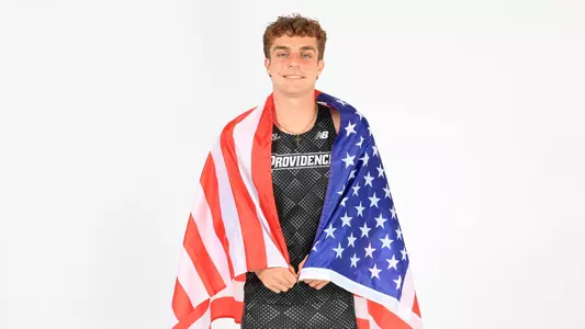 Ryan LoCicero holding the American flag around his shoulders while at a photo shoot 
