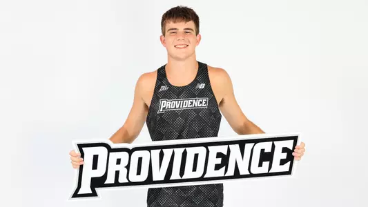 Dylan McCarthy holding the Providence sign during a photo shoot 