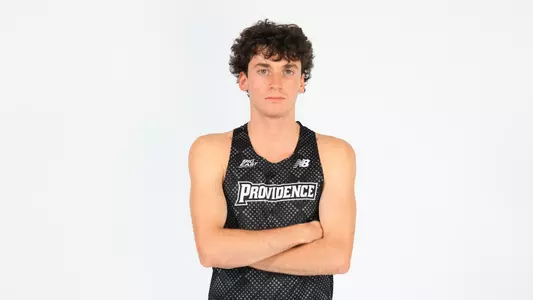 Elliott Pugh posing with his arms crossed during a photo shoot