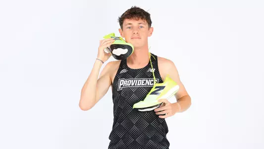 Jack Small pretending to pick up the phone with his spikes during a photo shoot