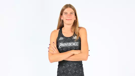 Kate Currie posing with her arms crossed during a photo shoot 
