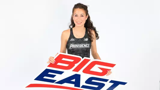Marguerite Slattery holding the Big East sign while at a photo shoot 