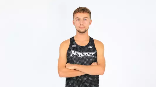 Sam Hodgson posing with his arms crossed during a photo shoot 