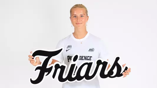 Women's soccer player Signe Tingager posing with a Friars sign during a photo shoot