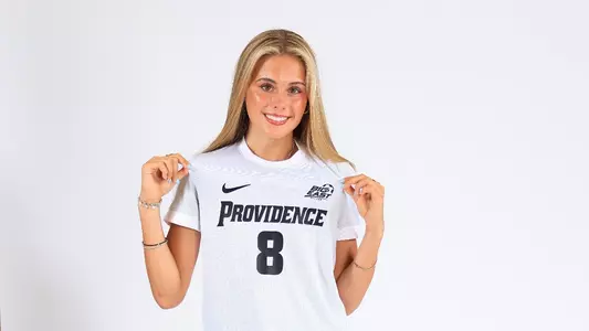 Kaitlyn Brady Pulling on Jersey Posing
