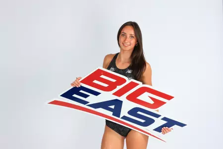 Keira Kelly posing with the Big East sign on media day