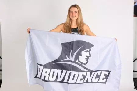 Cate Parks posing with the friar flag on media day