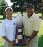Charlie Woo and Investors Group Regional Director Chuck Ealey pose with the Gary Cowan Trophy