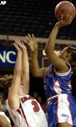 DePaul's Jarietta Benton, right, drives to the basket as Louisville's Katie Olson tries to draw a charge during action of their game Saturday Feb. 5, 2005 at Freedom Hall in Louisville, Ky.