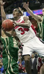 Larry O'Bannon drives past a pair of UAB defenders in the first half of Louisville's 74-67 C-USA semifinal victory over UAB.