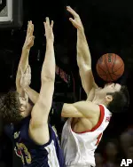 Louisville's David Padgett has the ball bounce off his nose as he goes against Pittsburgh's Aaron Gray during the first half of their basketball game Sunday, Jan. 15, 2006, in Louisville, Ky. (AP Photo/Ed Reinke)