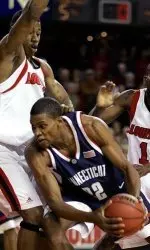Connecticut's Rudy Gay is stopped by Louisville's Terrence Williams as Brandon Jenkins (11) offers help during the first half. (AP Photo/Ed Reinke)