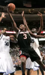 Juan Palacios drives by Villanova's Will Sheridan (50) and Shane Clark (35) in the first half. (AP Photo/George Widman)