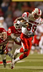 Louisville's Harry Douglas (85) tries to get away from Rutgers' Ron Girault (43), center, and Brandon Renkart (47) after a reception. (AP Photo)