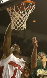 Terrence Williams dunks past the defense of Sacramento State's Angel Alamo. (AP Photo/Timothy D. Easley)