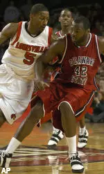 Taquan Dean, left, blocks the drive of Delaware State's Troy Roundtree. (AP Photo)