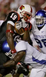 Michael Bush is tackled by Kentucky defenders.