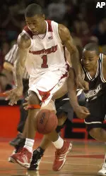 Providence's Sharaud Curry, right, battles Louisville's Terrence Williams for a loose ball during second half action of a basketball game Saturday, Jan. 13, 2007, at Freedom Hall in Louisville, Ky. (AP Photo/Timothy D. Easley)