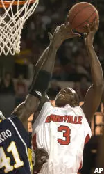 Juan Palacios shoots over Marquette's Ousmane Barro during the second half. (AP Photo/Timothy D. Easley)