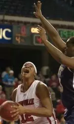 Louisville's Jazz Covington, left, looks for an opening through the defense of Pittsburgh's Marcedes Walker in the second half. (AP Photo/Timothy D. Easley)