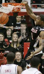 Louisville forward Terrence Williams dunks the ball in the first half. (AP Photo/Al Behrman)