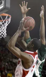 Louisville's Earl Clark, left, tries to score inside around South Florida's Adamu Saaka during the first half of their basketball game in Louisville, Ky., Saturday, Feb. 10, 2007. (AP Photo/Garry Jones)