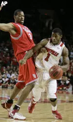 Louisville's Terrence Williams drives around St. John's Lamont Hamilton in the first half. (AP Photo/Ed Reinke)
