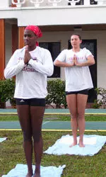 No, the Cardinals aren't praying for spring break to last longer in sunny Florida, but are taking a yoga class prior to Saturday's tournament. Lecia Brown (red scarf) and Elena Pilnikova practice yoga.