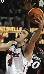 David Padgett gets a shot off past the defense of Cincinnati's Anthony McClain during second half action. This was Padgett's first game back for the Cardinals since breaking his kneecap on Nov. 18, 2007.(AP Photo/Timothy D. Easley)