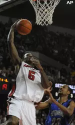 Louisville's Earl Clark, left, goes up for a dunk past the defense of Seton Hall's Robert Mitchell during the first half. (AP Photo/Timothy D. Easley)
