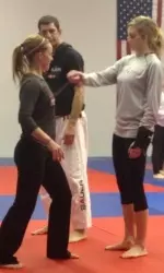 The field hockey team participated in a self-defense class as part of the L-Care program