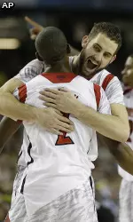 Luke Hancock and Russ Smith embrace after the game.