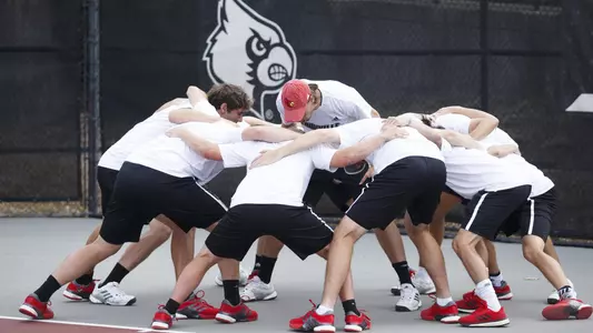 Louisville men's tennis huddles pre-match. 