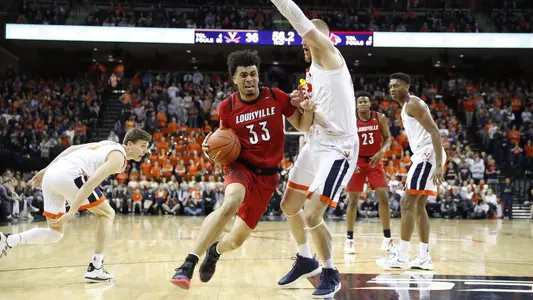 Jordan Nwora drives to the basket against Virginia