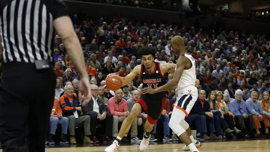 Jordan Nwora drives to the basket against Virginia
