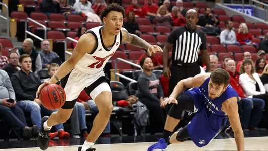 Josh Nickelberry drives around an Indiana State player in the KFC Yum! Center.