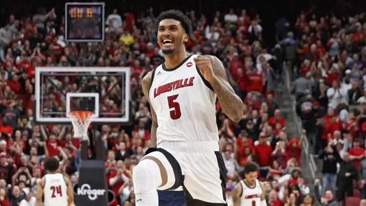 Malik Williams celebrates on the court with UofL's victory over Virginia